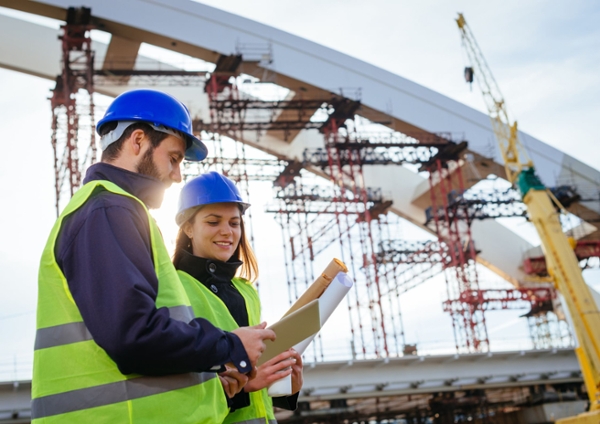 Two people in a construction site.